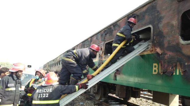 Pakistan firemen board the train that set alight on 31 October